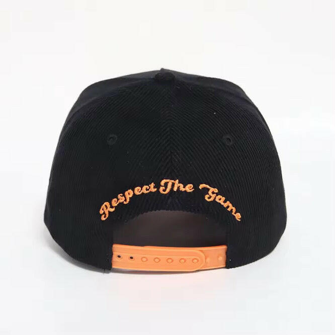 Back view of black & orange corduroy snapback hat with Respect The Game embroidery and adjustable snapback strap