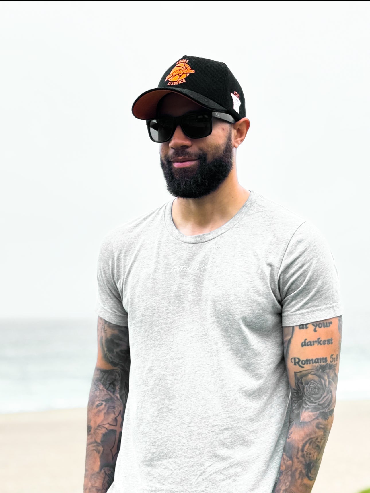 Man wearing black & orange corduroy snapback hat by the beach – lifestyle shot