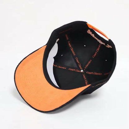 Interior view showing orange underbrim and Court Classics taping on black & orange snapback hat – 5-panel design